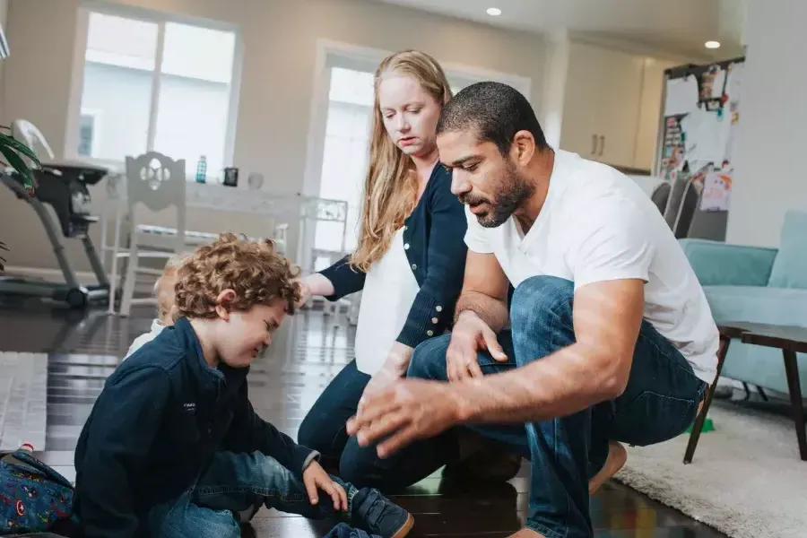 Romulo Melo and his wife playing with their son.